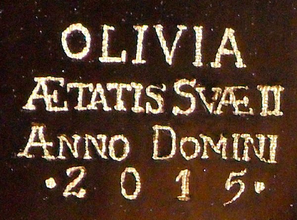 Close-up of gold-leaf lettering - 24ct gold. 'Olivia - Ætatis Suæ II - Anno Domini 2015' (Olivia - aged 2 - the year 2015). Copyright (c)2016 Paul Alan Grosse