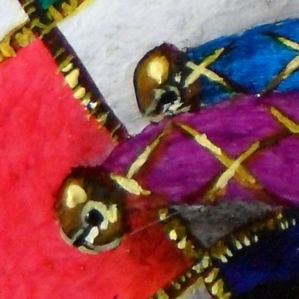 Close-up of the golden bells at the ends of the 'protrusions' on the toy's headdress. Copyright (c)2017 Paul Alan Grosse