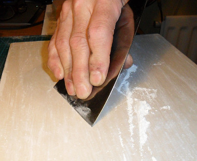 Quarter cut oak panel. scraping a shine onto the panel. Copyright (c)2017 Paul Alan Grosse