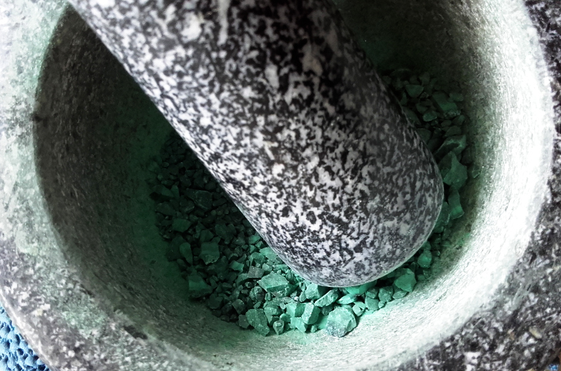 Grinding up pigment in a mortar and pestle. Copyright (c)2020 Paul Alan Grosse