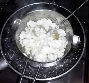 Melting the wax and resin in a porringer. Copyright (c)2020 Paul Alan Grosse