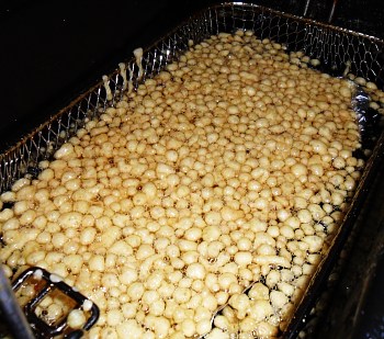 First, the batter balls sink and then they rise up and fry on the surface.