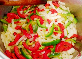 Onion, peppers and garlic frying in olive oil.