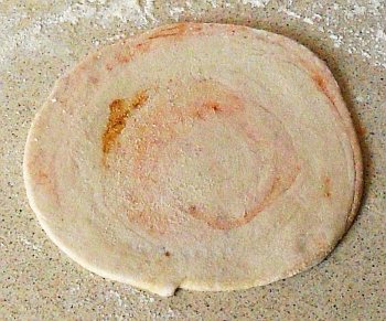 Flatten it to make the spiralled spiral paratha.