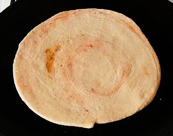 Fry it on a hot, oiled tava.
