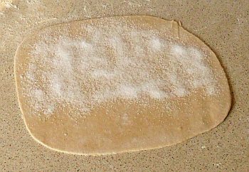 Sprinkle some caster sugar onto the dough-sheet, leaving a border on three sides.