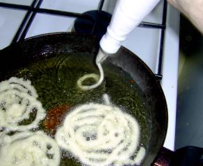 Pipe the batter into the oil