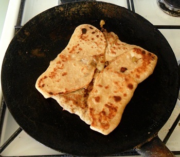 Turn it over when it is done enough. Remember that the dough will be a bit thicker on the folded side.