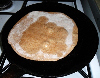 Fry the paratha in oil, sprinkling some more oil on the top.