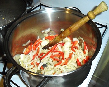 Onions and peppers. The wooden thing is a spurtle - far superior to a spoon