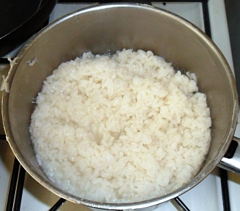 Boil the pudding rice until it is soft and starts to go sticky.